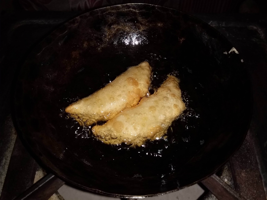 Frying Gujiyas as described in Gujiya Recipe.