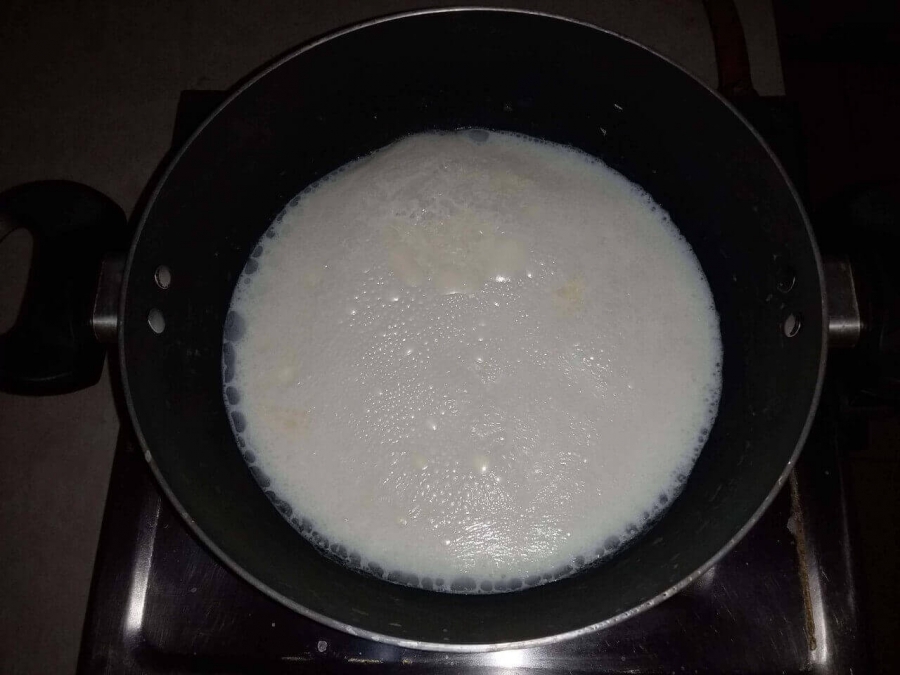 Milk being condensed by boiling in Recipe of Milk Peda.
