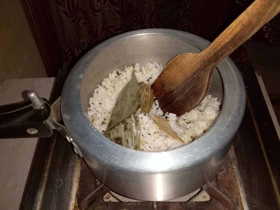 Jeera Rice being prepared in pressure cooker.
