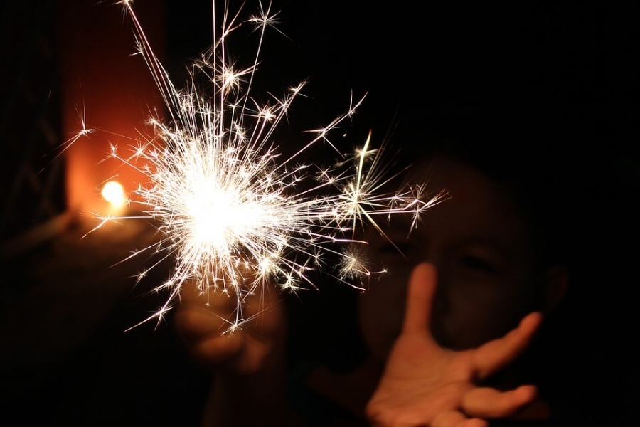 A child playing with sparklers in Diwali.