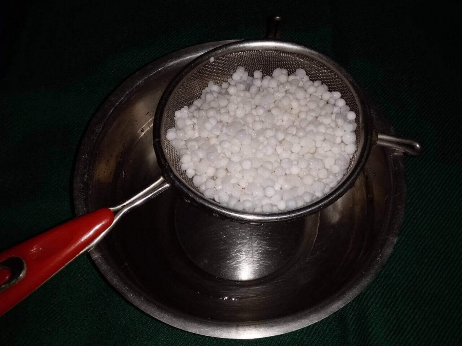 Transfer the wet Sabudana on a sieve to separate  extra water as described in Sabudana Khichdi Recipe.