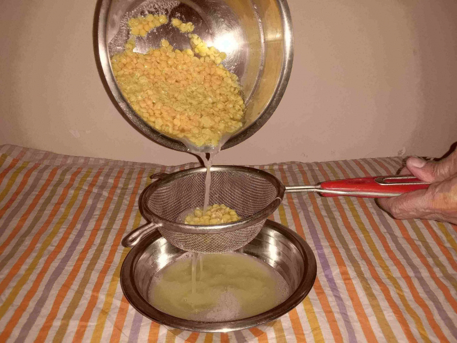 Separating the water from the boiled dal as described in Recipe of Puran Poli.