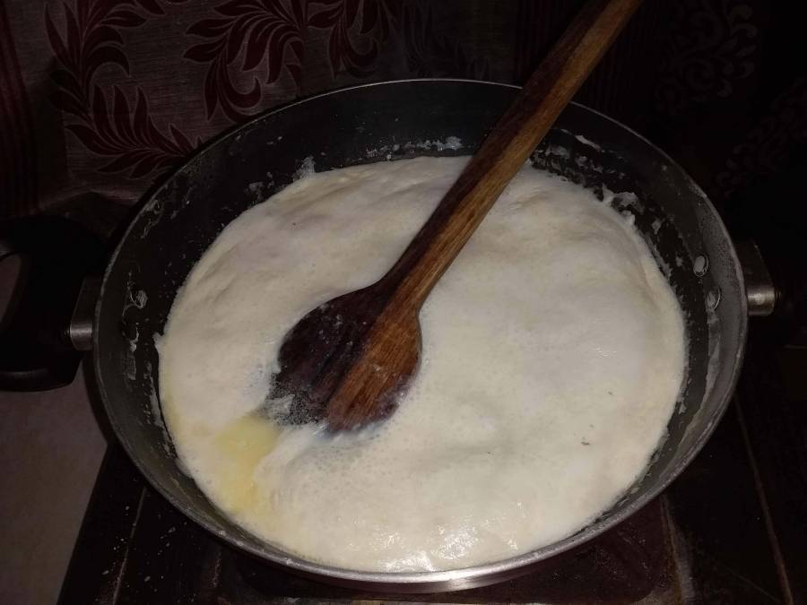 Condensing the milk by boiling, while preparing milk cake.