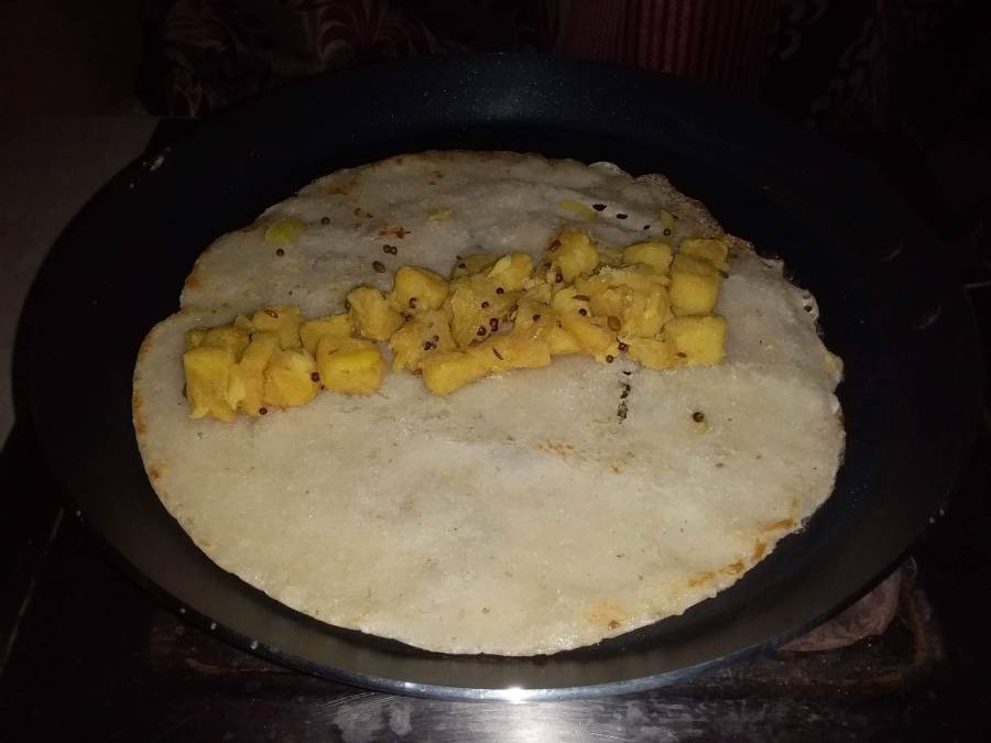 Stuffing being placed inside the dosa.