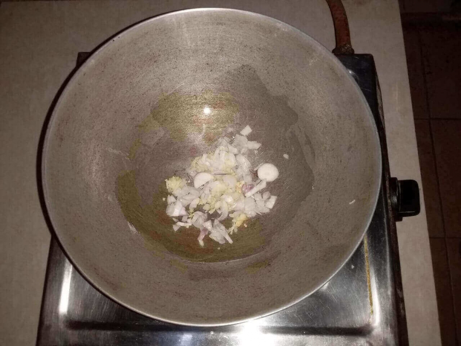 Onion and Garlic pieces being fried in Recipe of Mix Vegetable Soup.