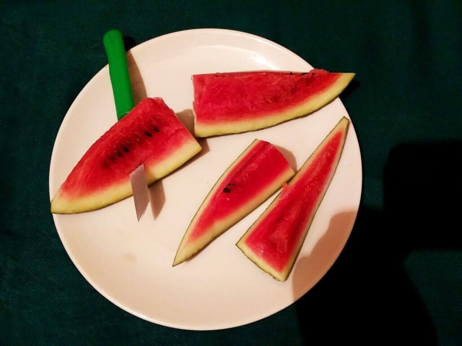 Each part being horizontally  sliced into 2 halves as described in Recipe of Watermelon Juice preparation.