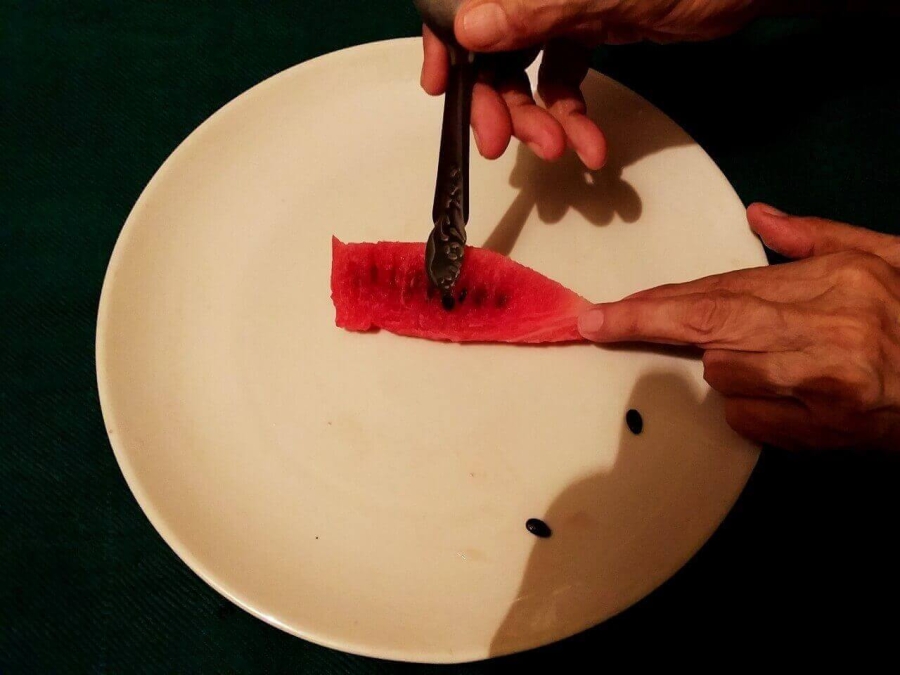 Seeds being removed from juicy red region as described in Watermelon Juice Recipe preparation.