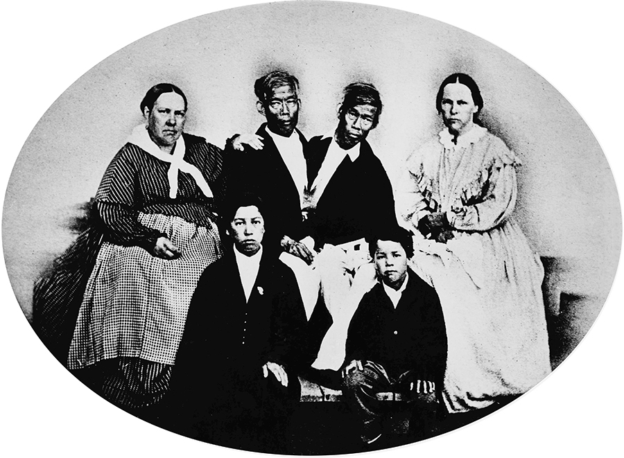 Photograph of Chang, his wife Adelaide & their son Patrick Henry & on the left is Eng, his wife Sarah & their son Albert.