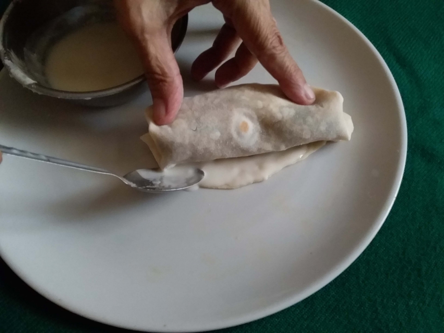 Open part of the Spring roll being closed by batter.