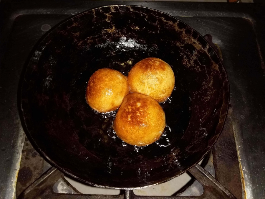 Gulab Jamuns being fried as described in Gulab Jamun Recipe.