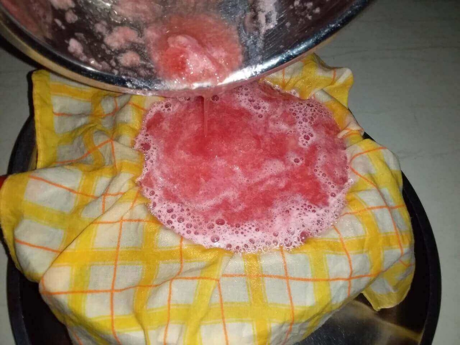 Watermelon juice being sieved as described in Recipe of Watermelon Juice preparation.