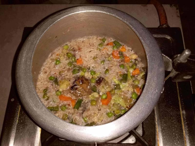 Veg Pulao being prepared as described in Recipe of Veg Pulao.