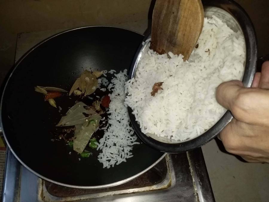 Preparing Jeera Rice in a pan.