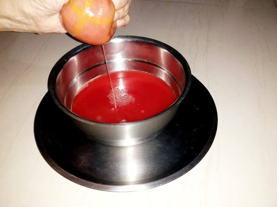 The watermelon juice being squeezed out from the residue collected over the cloth, as described in watermelon Juice Recipe preparation.