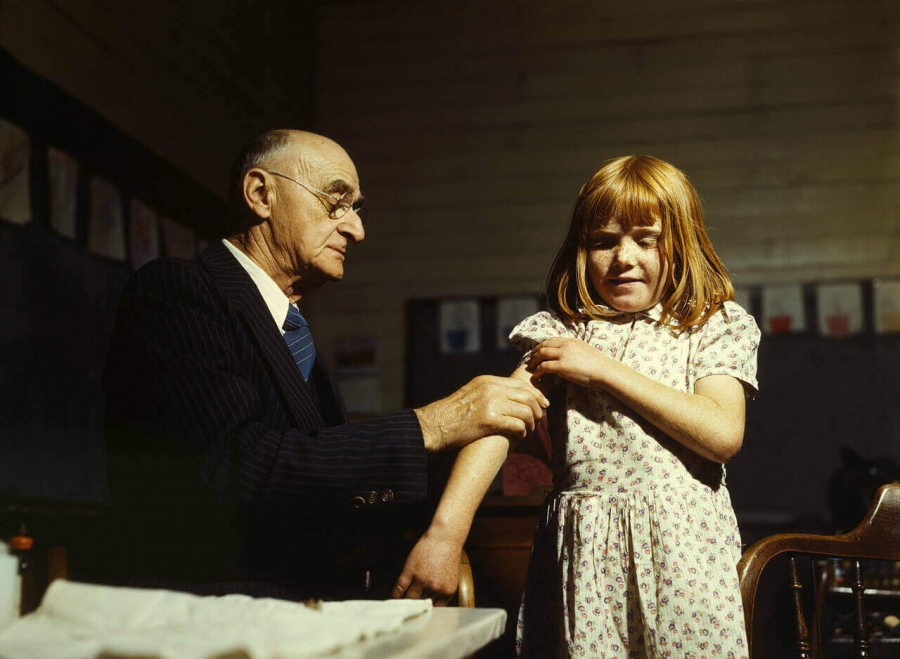 Doctor administering typhoid vaccination at a school in San Augustine County, Texas, 1943.