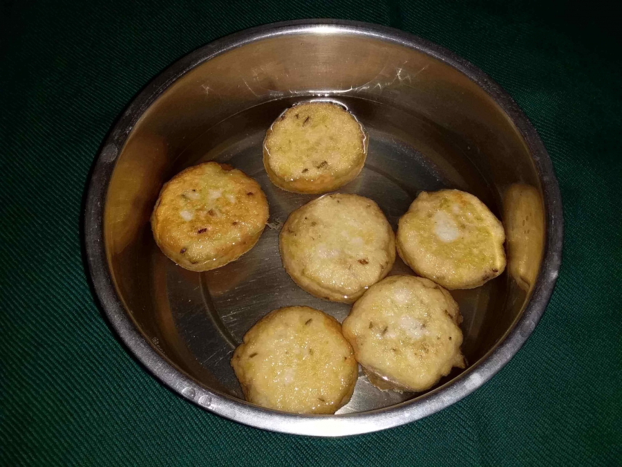 Fried Vada kept immersed in water as described in Recipe for Dahi Vada.
