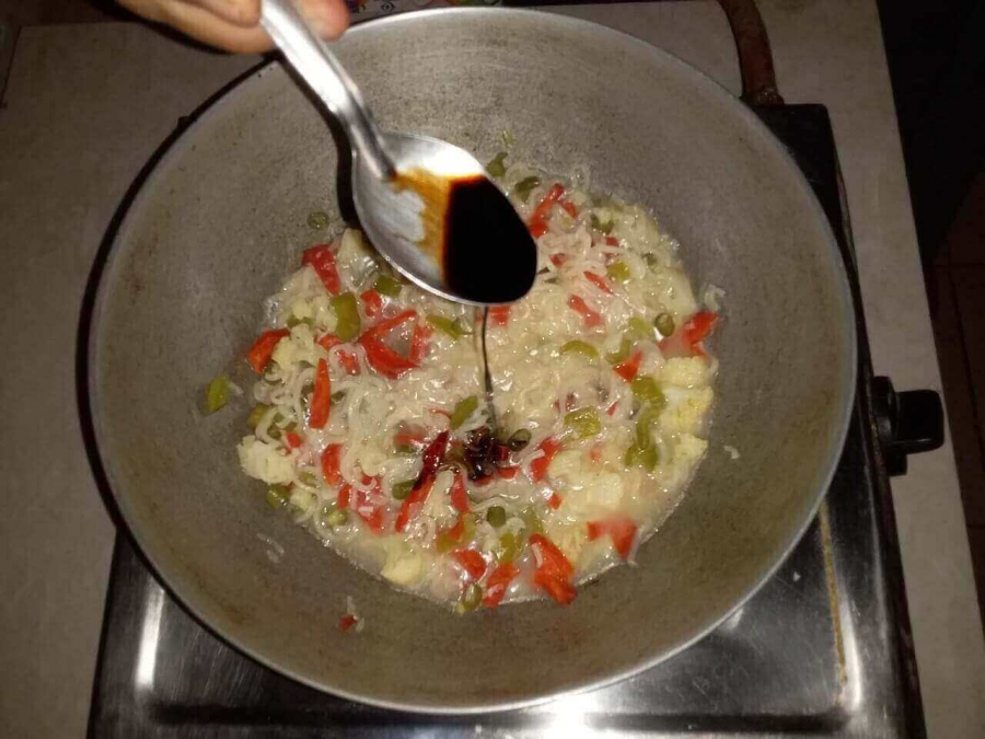 Soy Sauce being added to the preparation as described in Vegetable Soup Recipe.